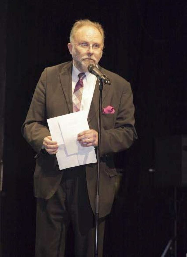 Mies ruskea puku päällä.